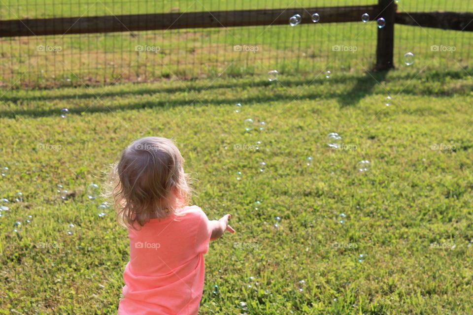 Playing outside with bubbles.