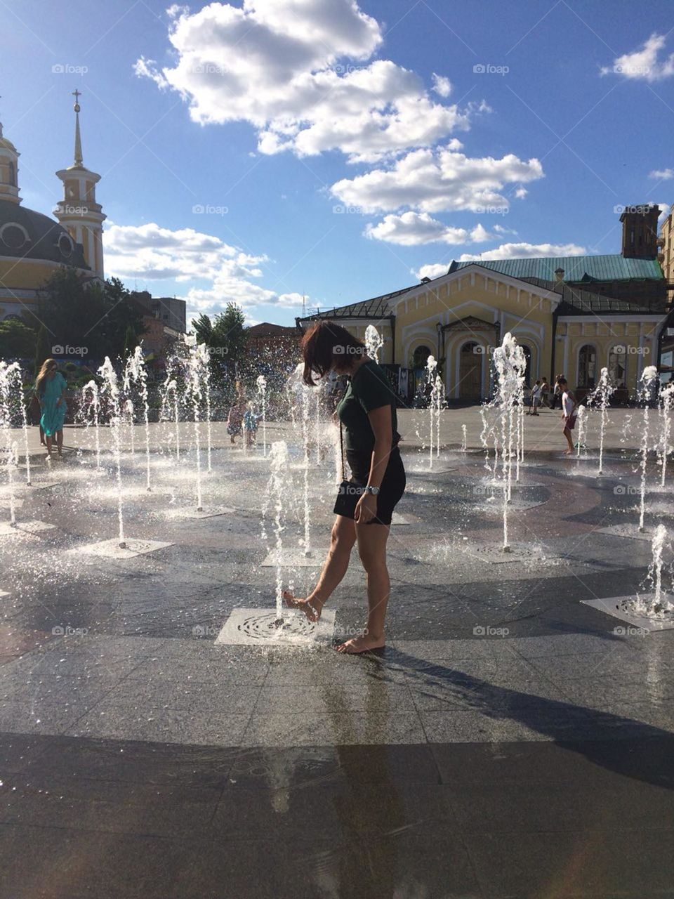 A walk in the city fountain in summer