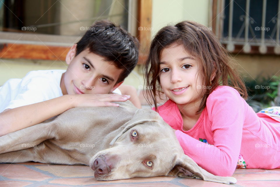 Brother and sister with their pet