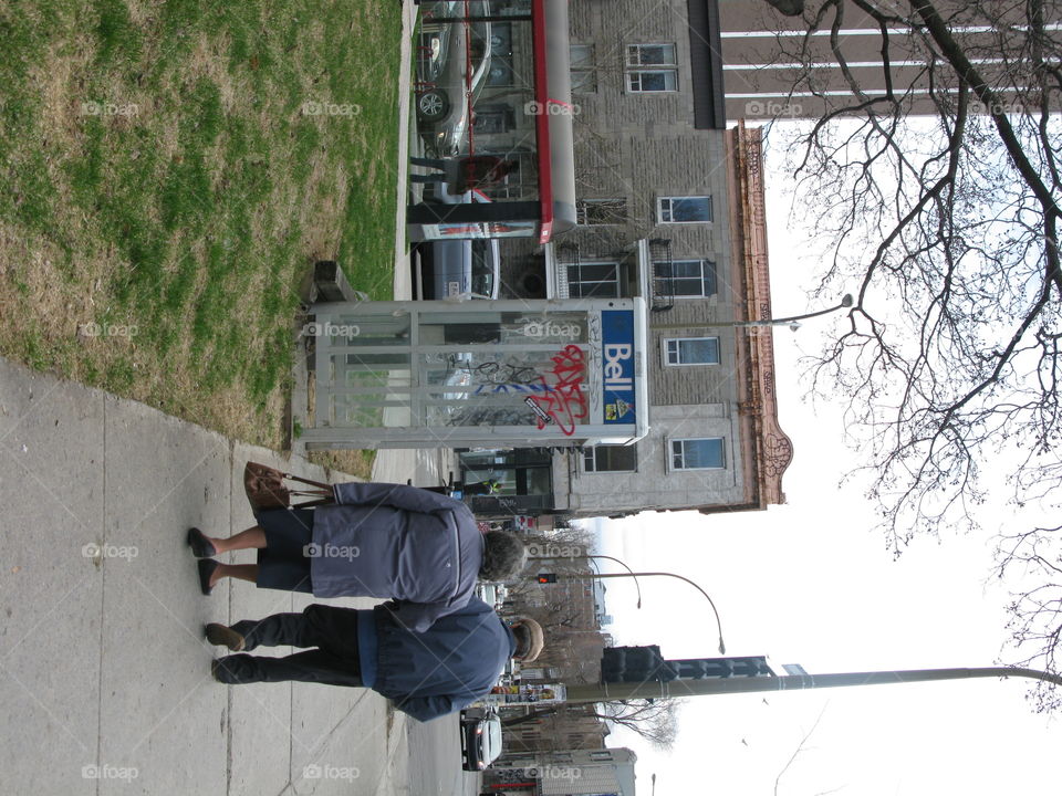 A elderly couple walking arm in arm, still in love