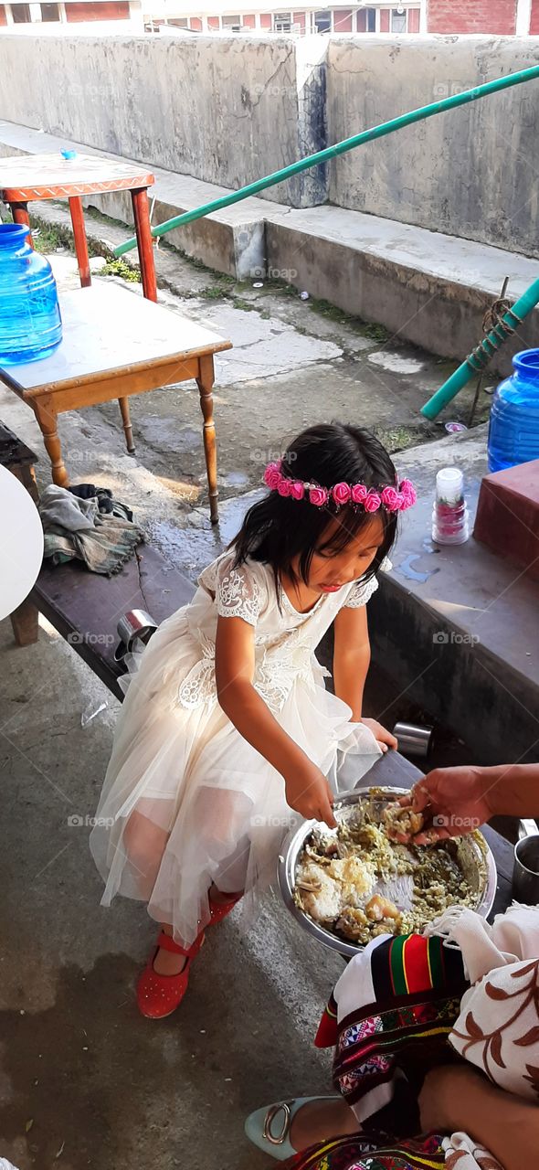 bridal child associted to bride in a wedding enjoying wedding feast
