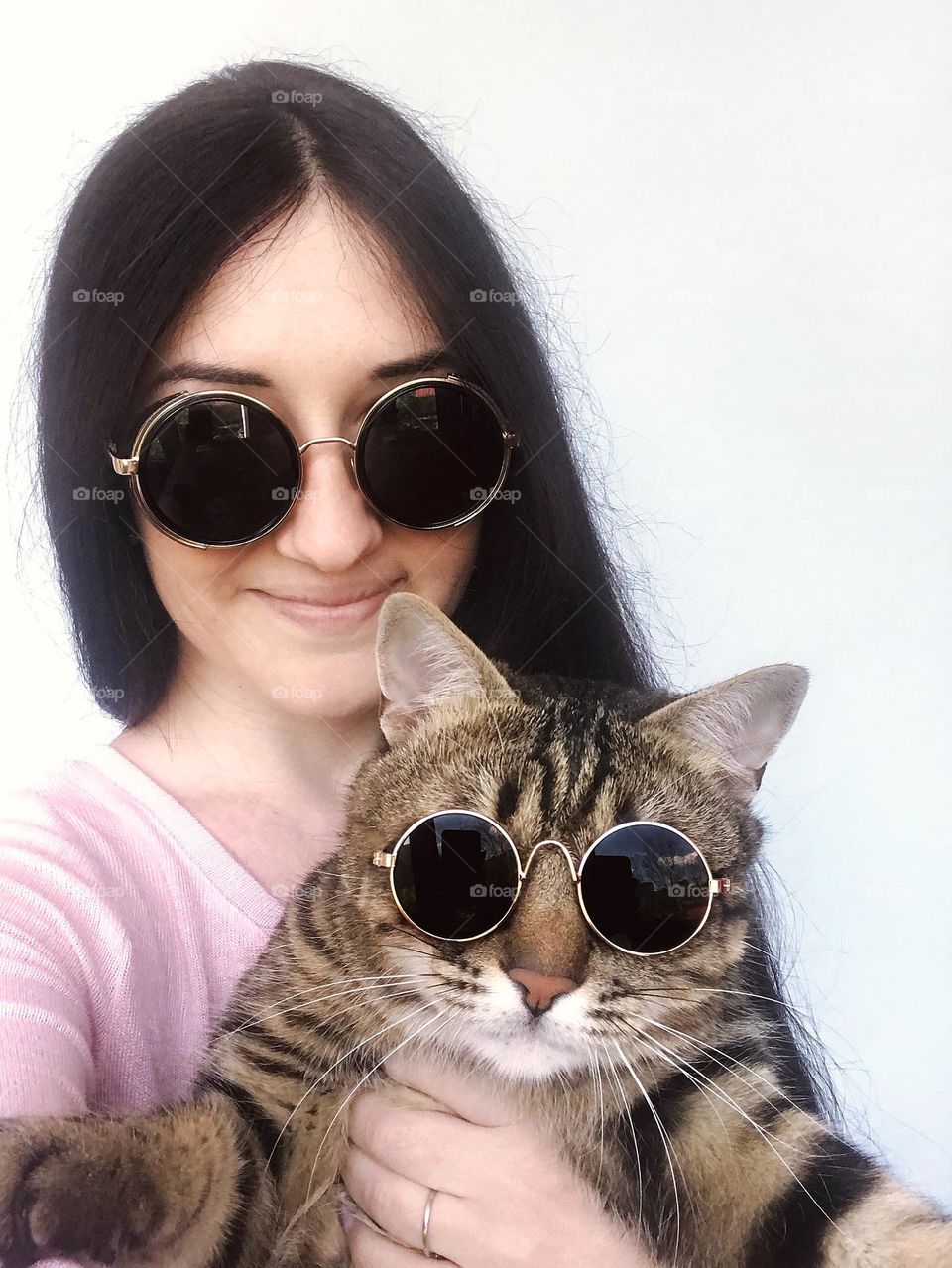 Funny selfie photo. Girl with cat on glasses