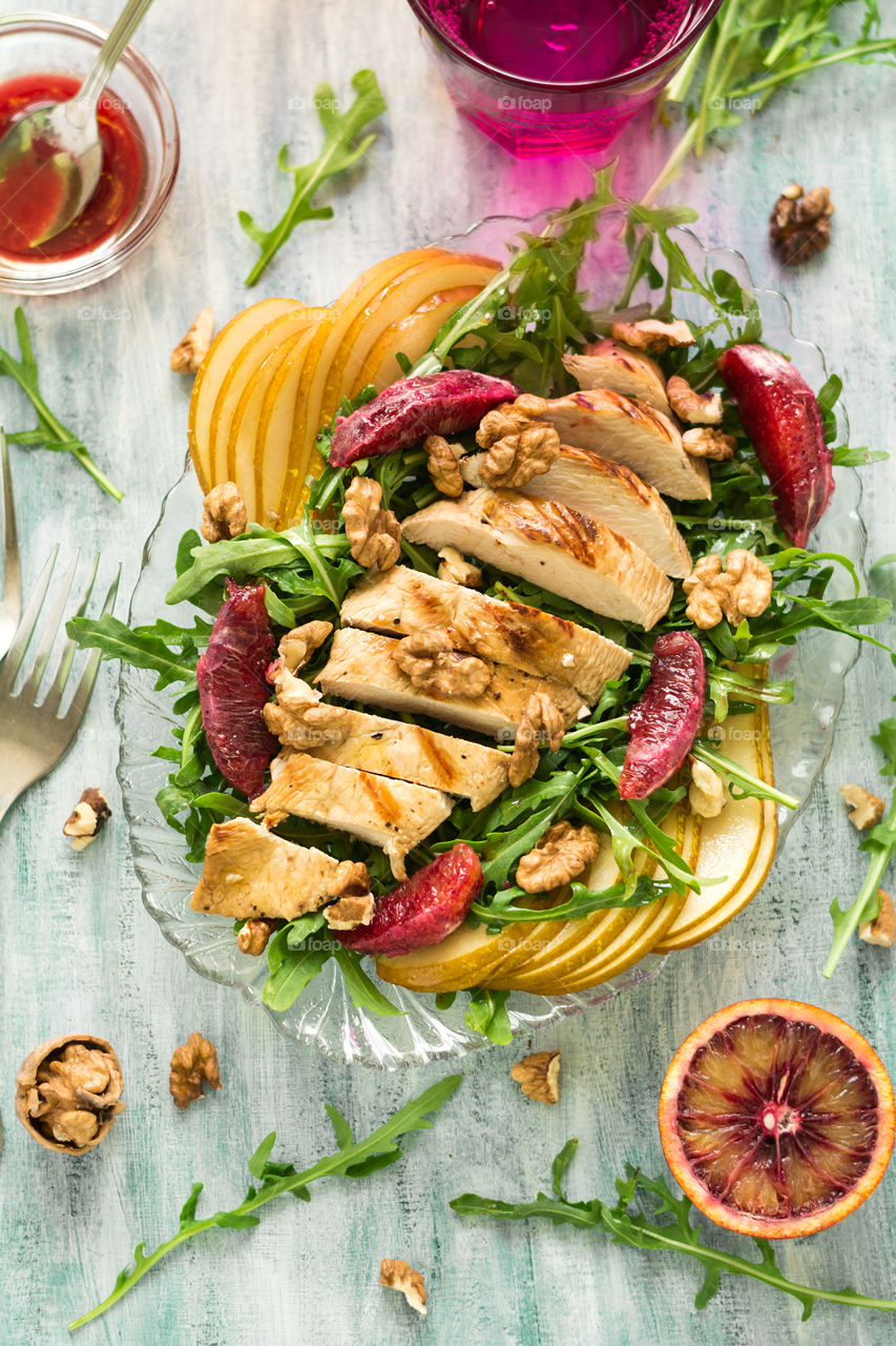 Grilled chicken breast with pear, blood orange, walnuts and arugula