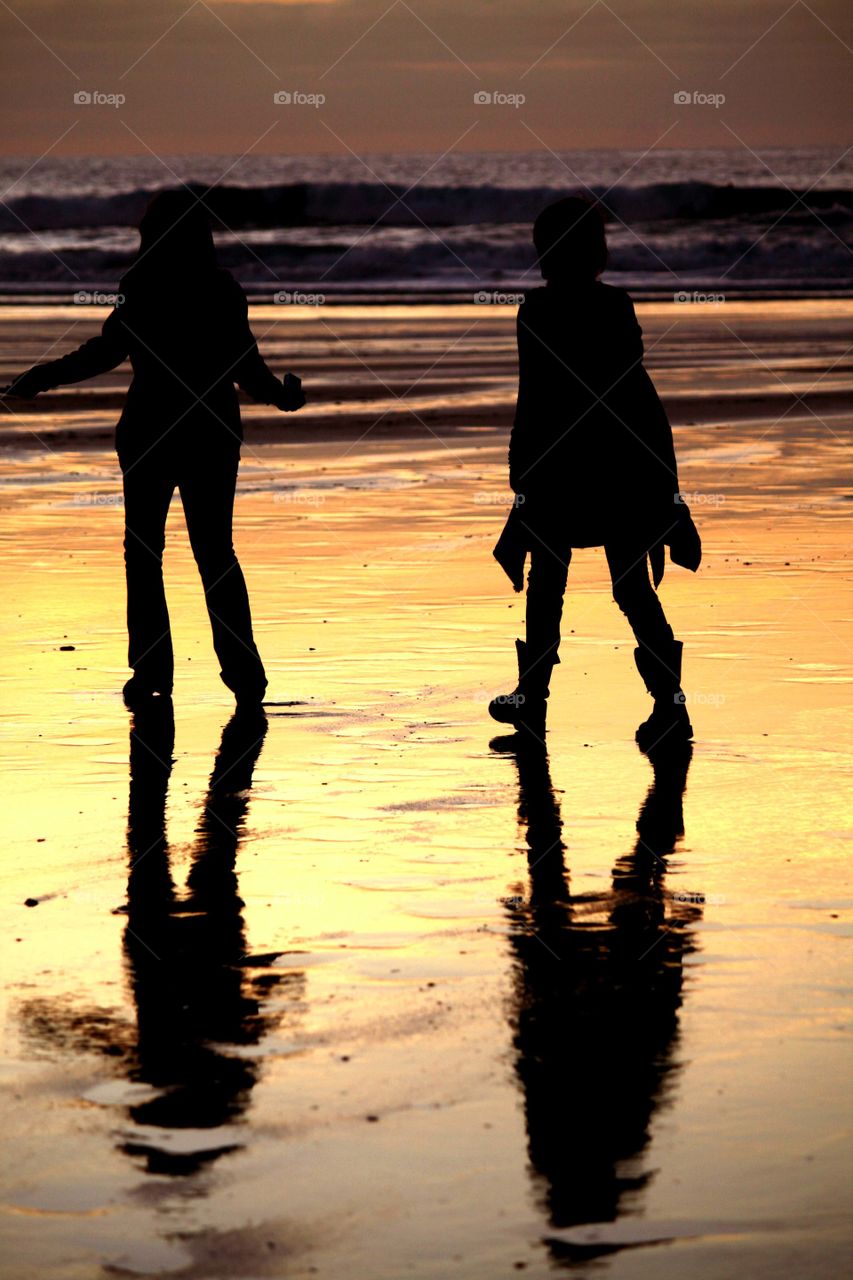 Frolicking on Fistral Beach. Sunset at Fistral beach in Cornwall, gorgeous patterns on the wet sand and silhouettes :) 