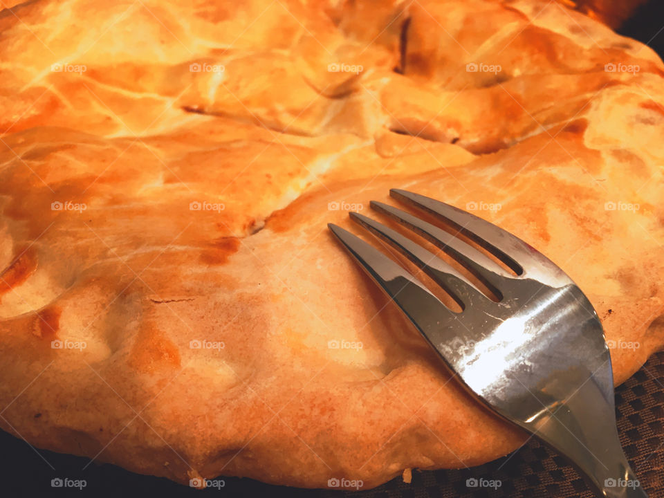 Close-up of fork on apple pie