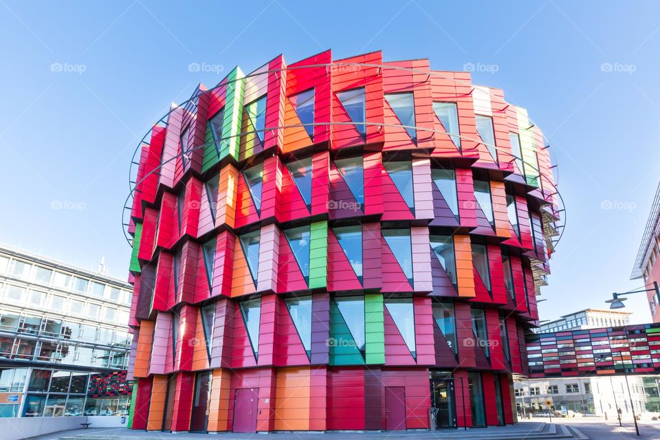 Colorful modern building in many bright colors with geometric windows and facade 