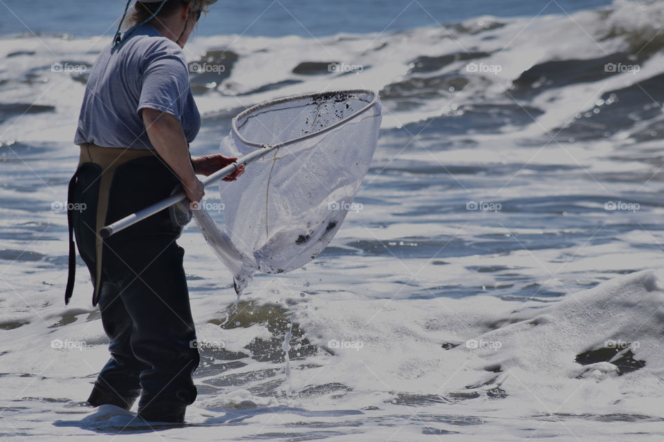 A woman fishing on the beach