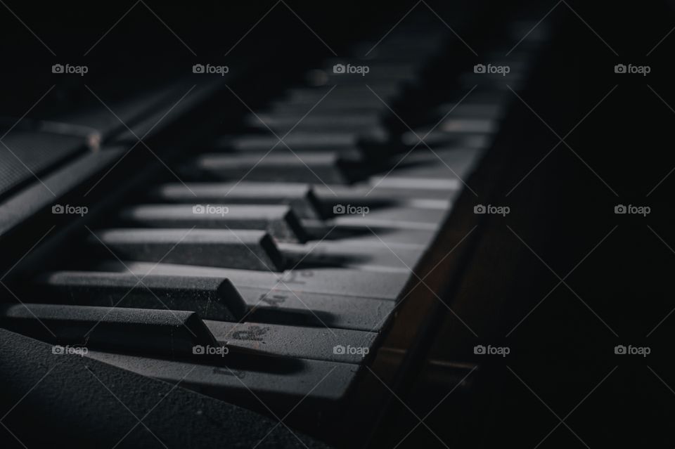 Close-up piano in the middle of darkness