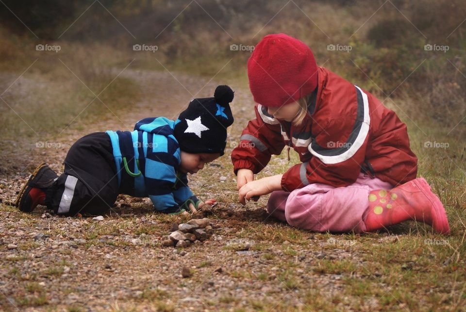 Brother and sister playing outdoors