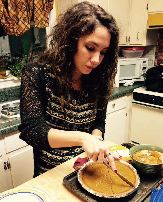 Woman preparing cake in kitchen