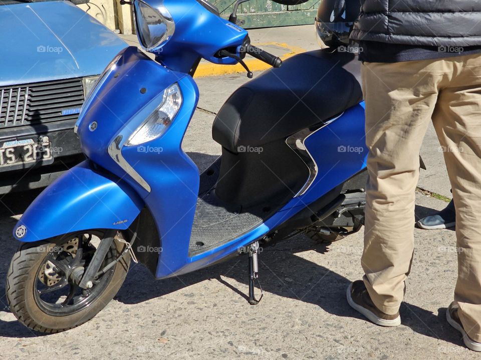 A metallic blue scooter could be your best option for your commute.  It's less expensive than a motorbike and has a smaller footprint.