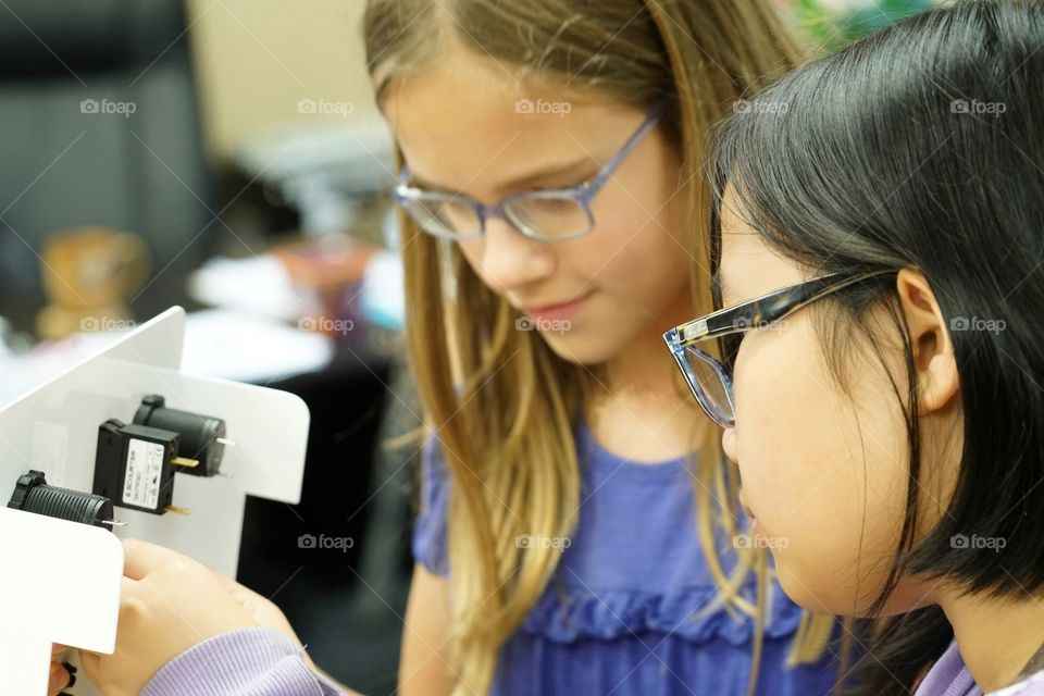 Girls Working Together With Technology