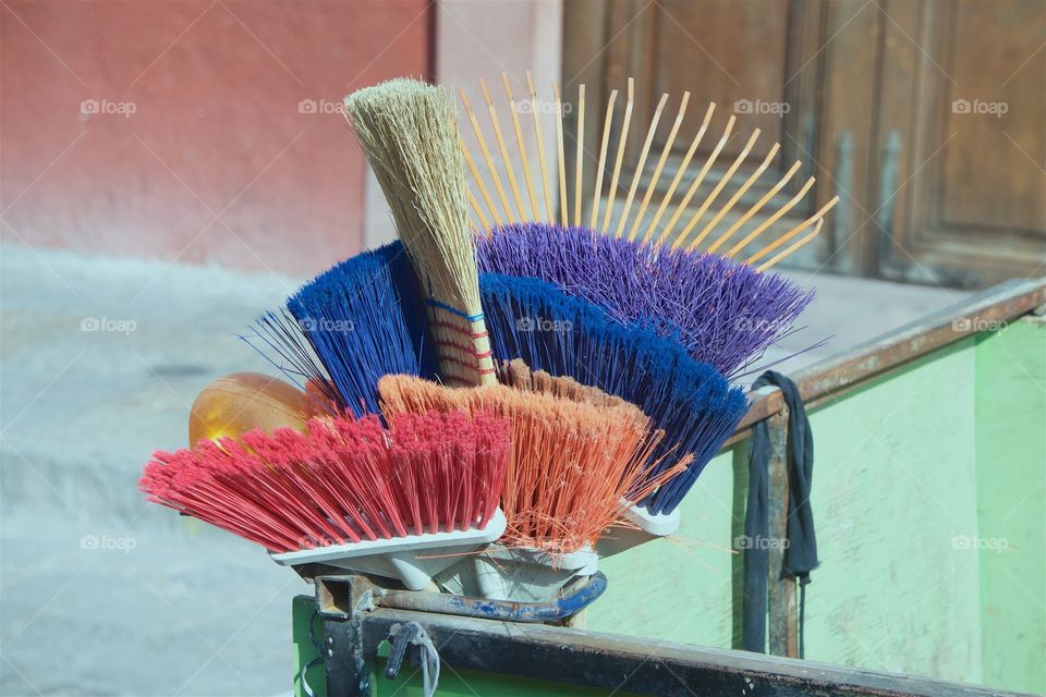 Coloful Cleaning tools being transported on the back of an open truck.