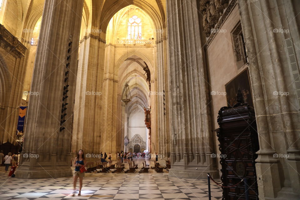 A tourist gazes up at the ceiling inside Seville cathedral, Spain