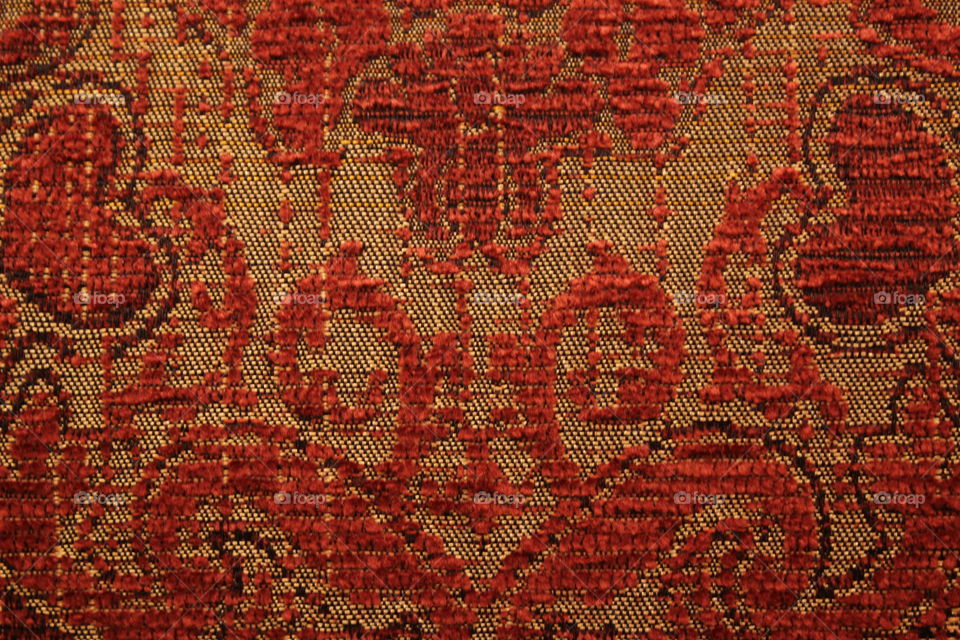 Multi-patterned red chair with hearts close-up