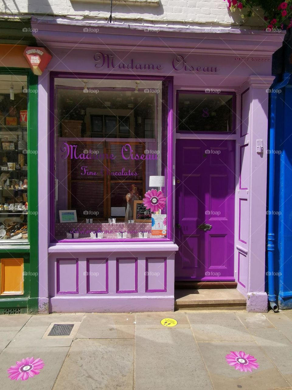 Colourful building. Door and window. Lavender colour. Spring time. Street photo.