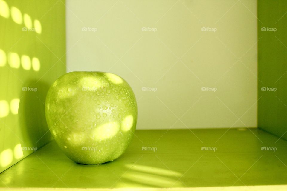 Green apple on green background