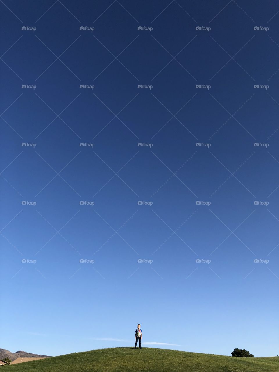 Golf course with small boy on hill