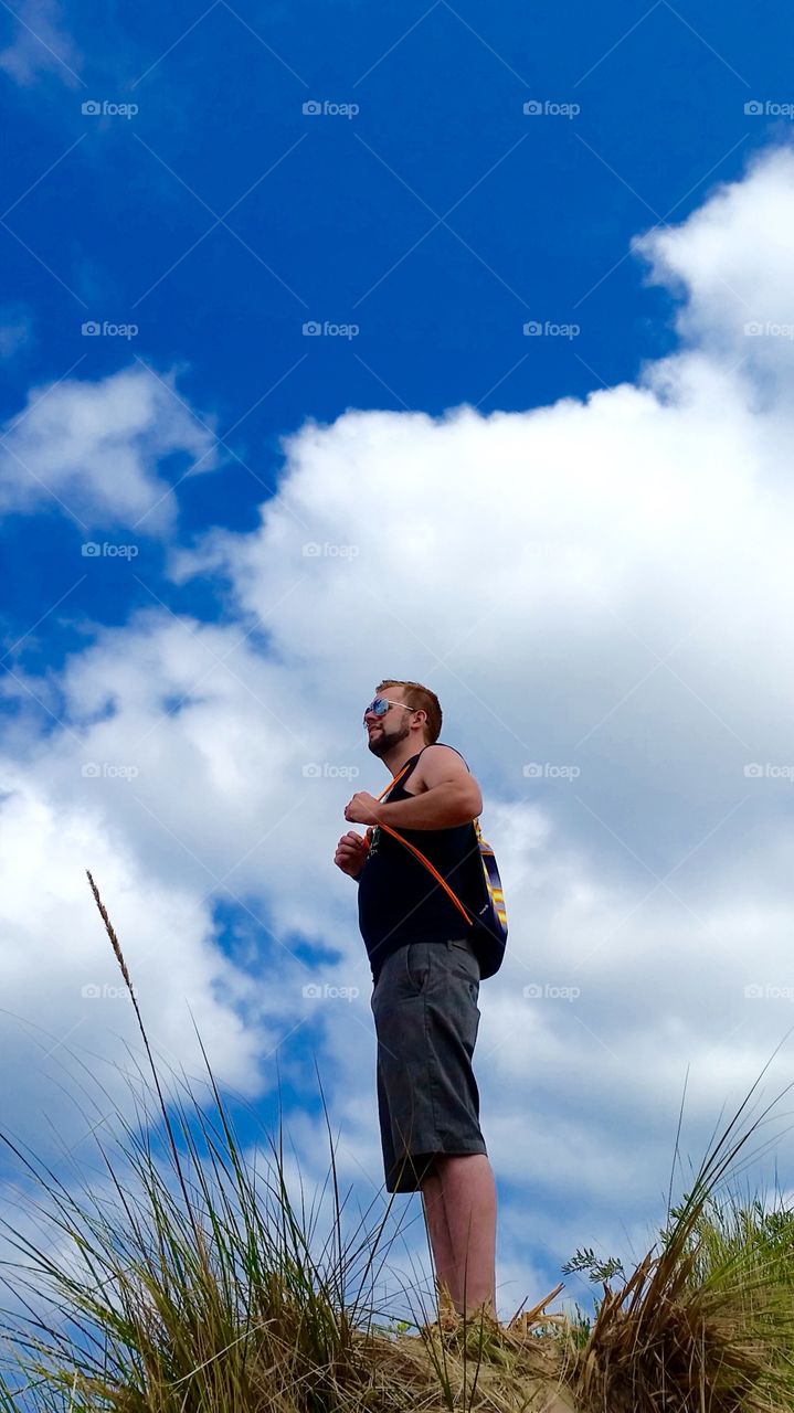 Low angle view of man standing on mountain