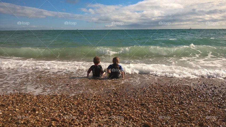 Children on the beach looking out to sea
