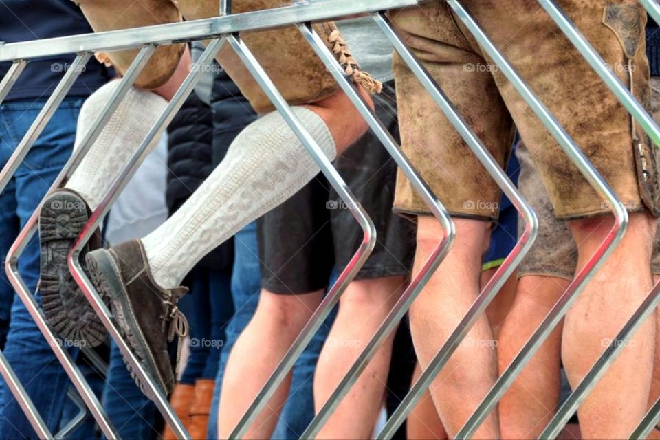 Close-up of many men's legs in traditional Bavarian lederhosen