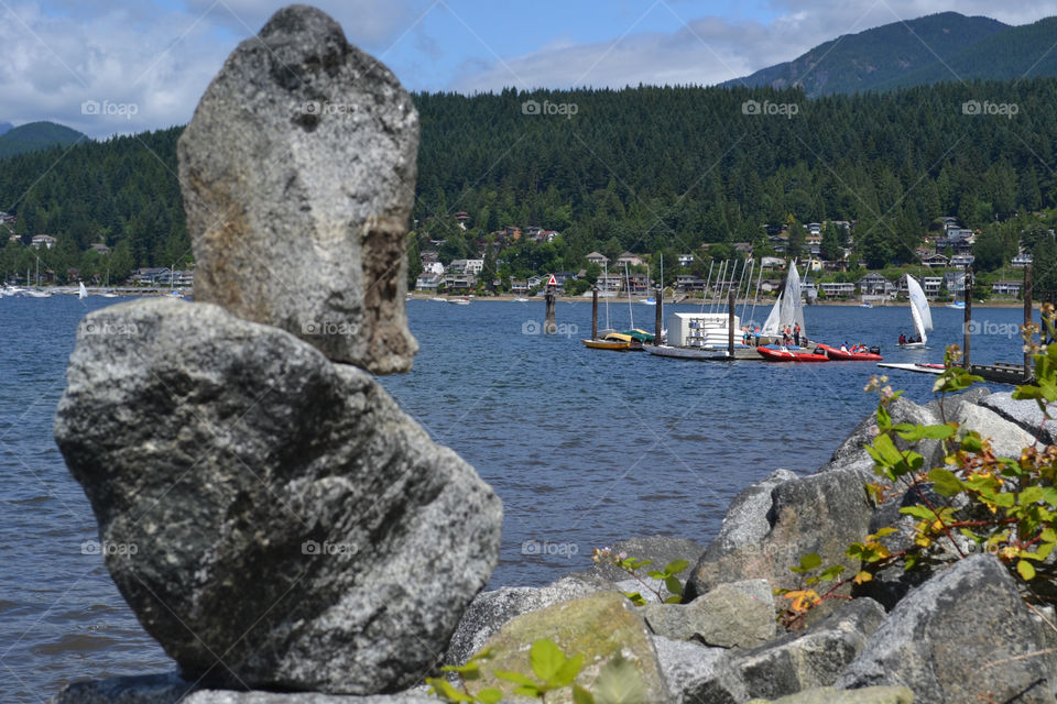 Rock stone stack overlooking ocean near Vancouver and toward north shore and west coast mountains
