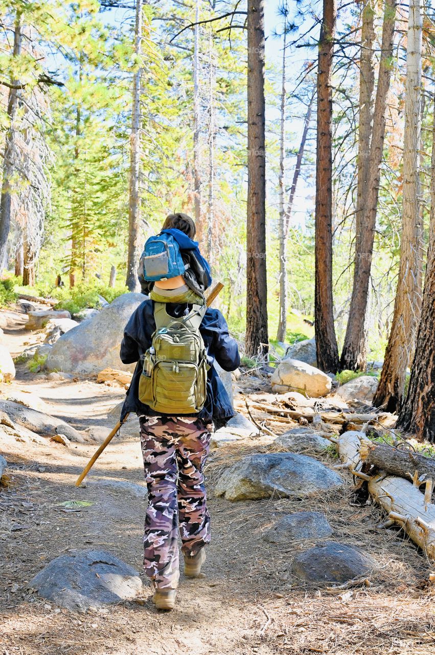 A long day hike in the immigrant wilderness, toddler felt tired and sleepy during the fall. 