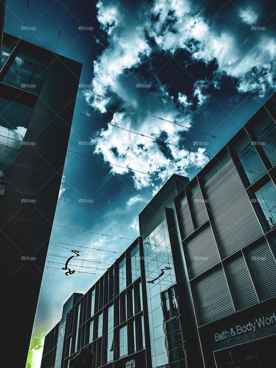 A building with glass windows and clouds in the sky