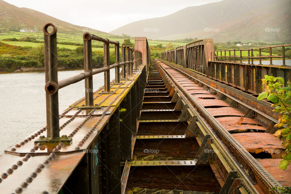 Shapes rectangle and squares as seen on this railway with steps leading into the distance.