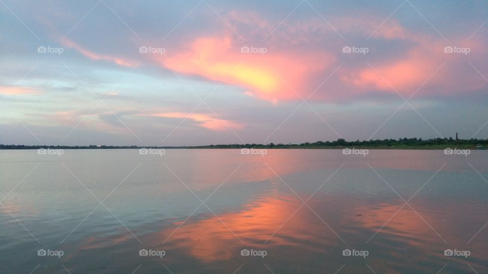a sunset scenario in evening when river makes the earth beautiful 😊.