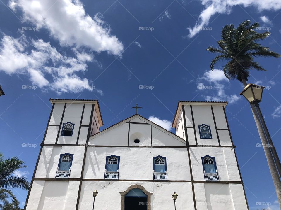 Church painted in white and blue windows and a blue sky