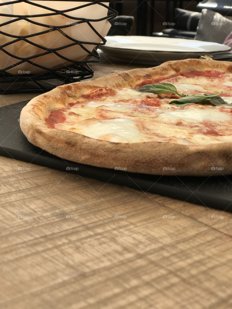 Fresh Italian pizza on a wood table. Delicious Pizza Margherita