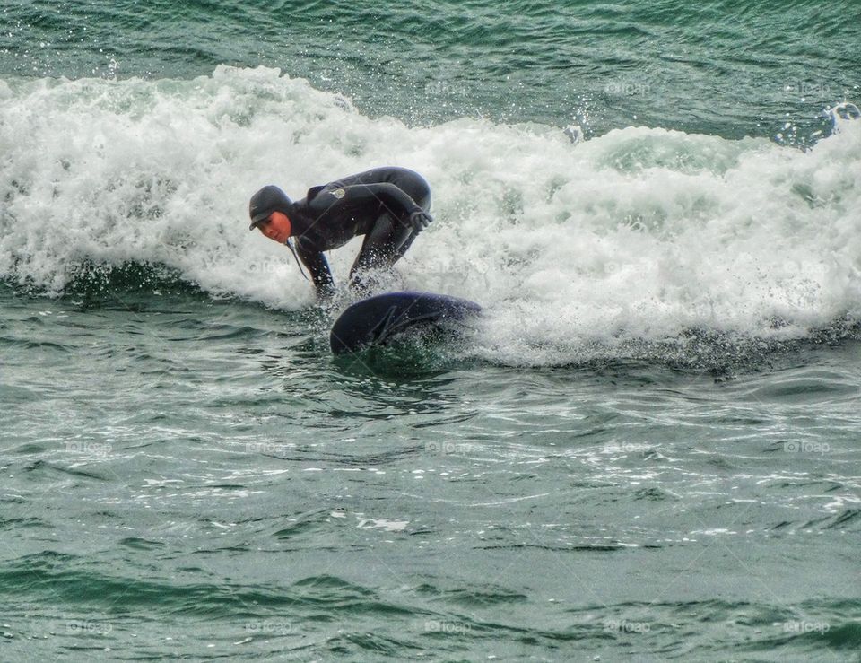 Athletic Woman Surfing The Pacific. Cold Water Surfing

