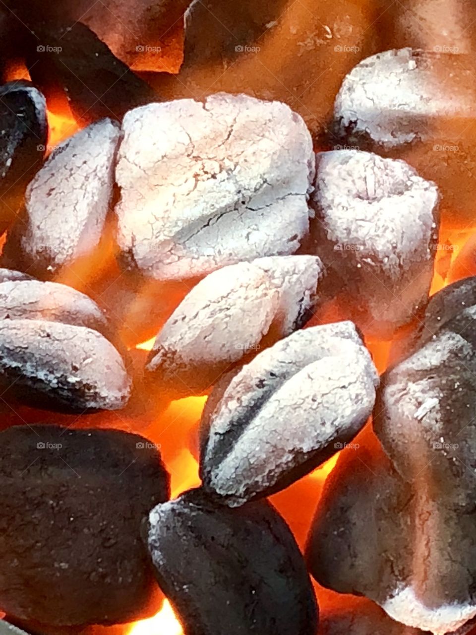 Close-up perspective of the glowing coalbed as the fire readies the hickory briquettes-