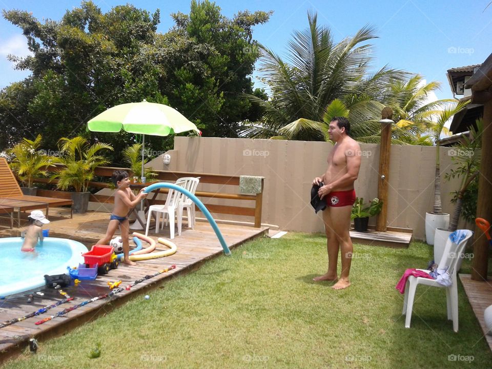 Uncle playing with nephew in the playground