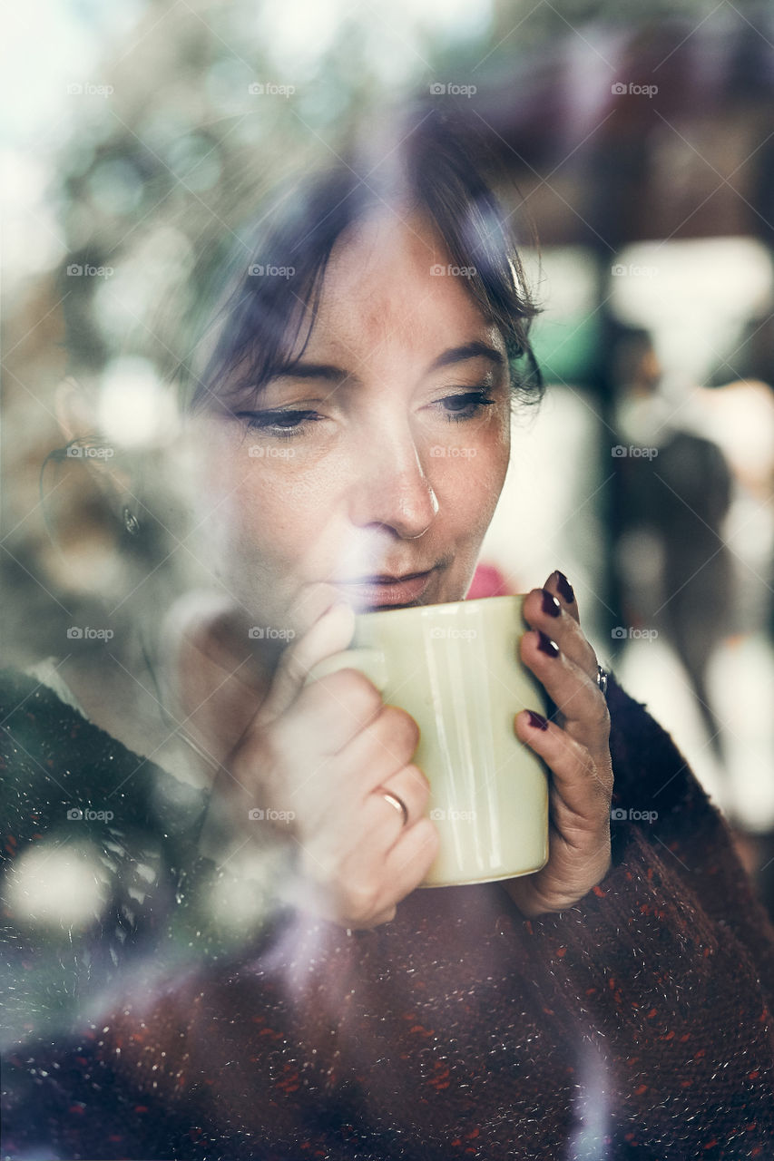 Portrait of woman drinking a coffee. Real people, authentic situations