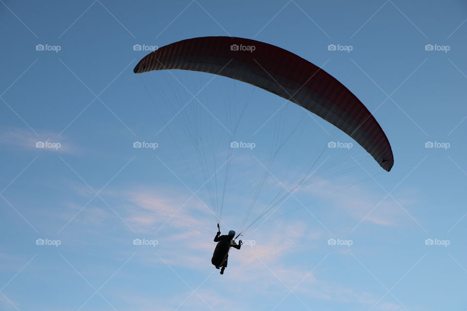 Paraglider against the blue sky- silhouette 