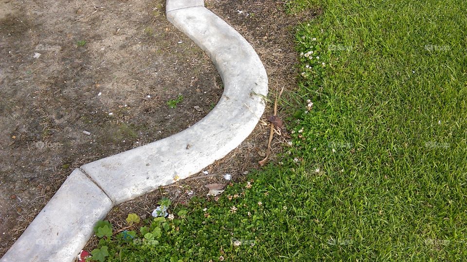 Shelter Island public recreation area, San Diego, CA.  The concrete stones mark where the edge of the green sward gives way to an unplanted small garden plot.