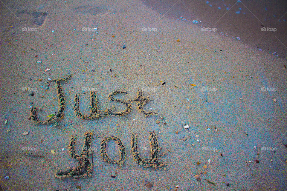 Just you text on a sand beach