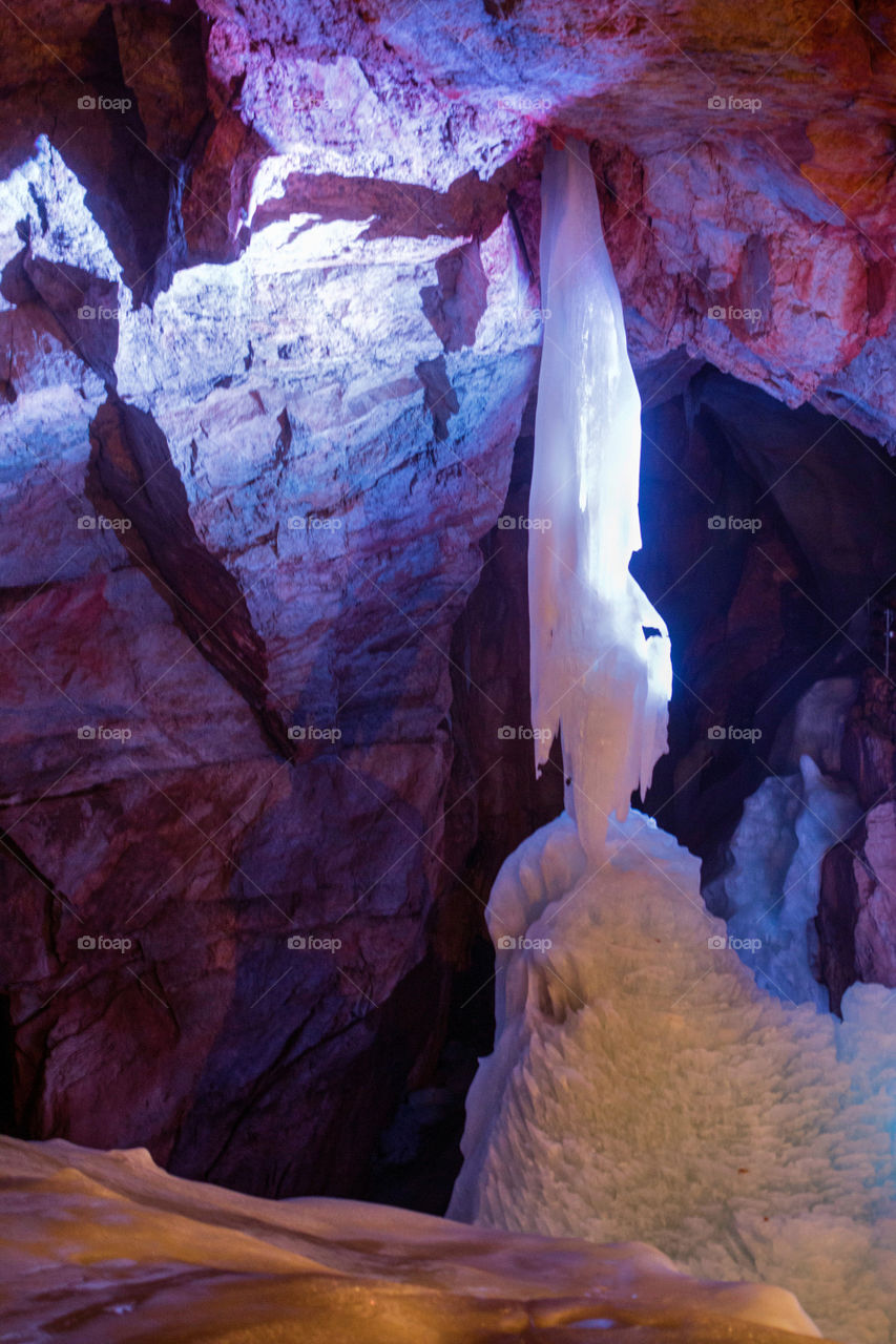 Purple light rock formation in cave