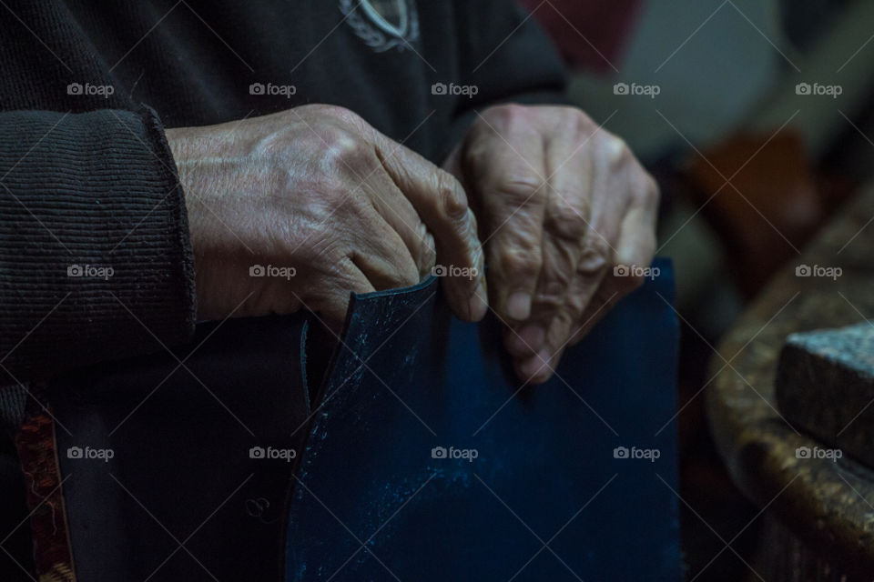 A person making leather bag