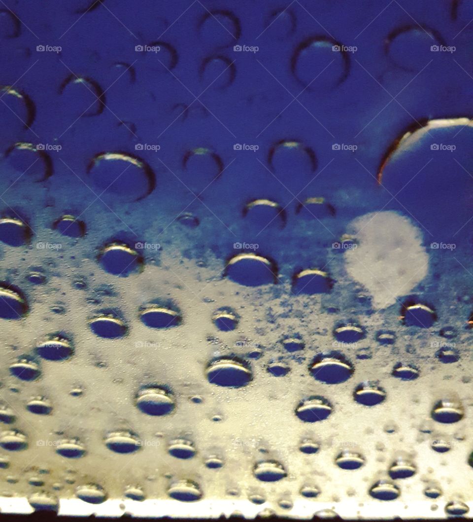 frozen water droplets on top of the sunroof of a car