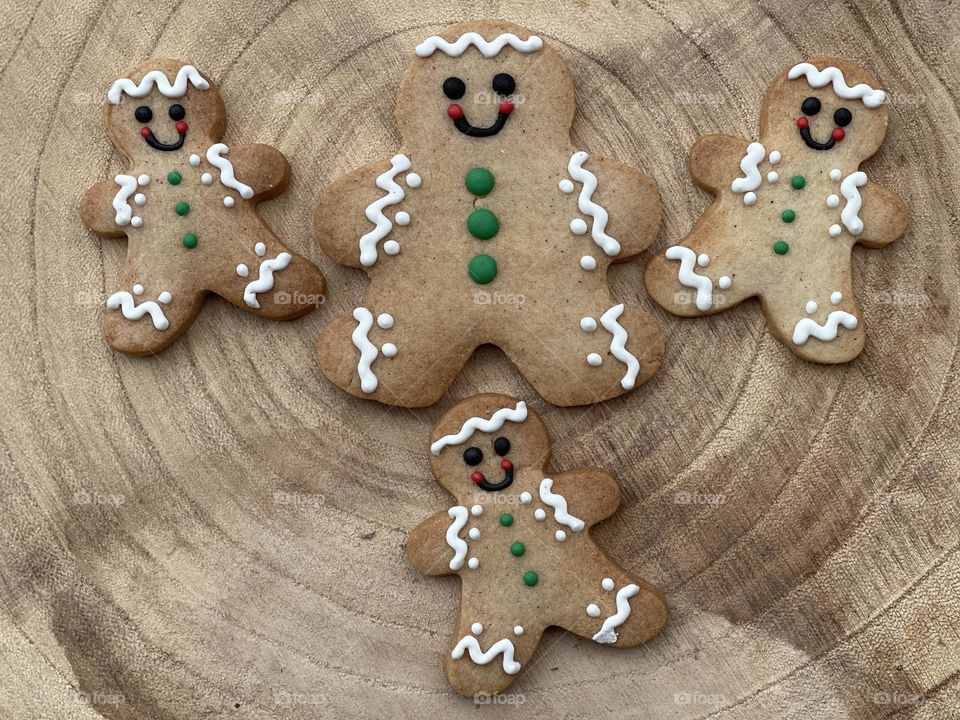 Three gingerbread on a wooden board for a Merry Christmas 