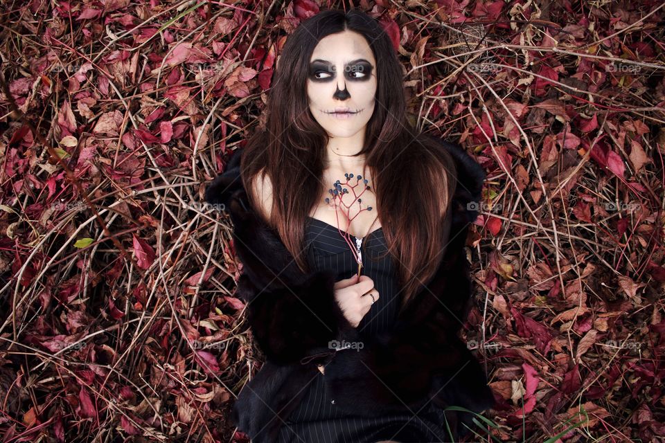Witch woman lying on leaves and stem