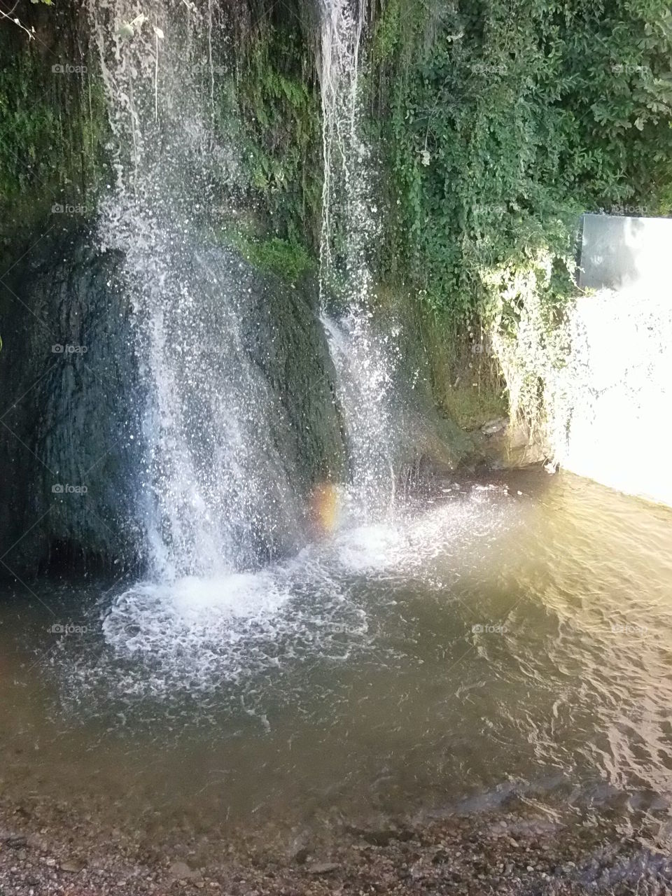 Suggestive waterfall with little rainbow