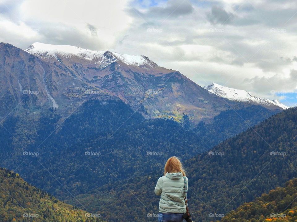 back view woman in the mountains on a hike