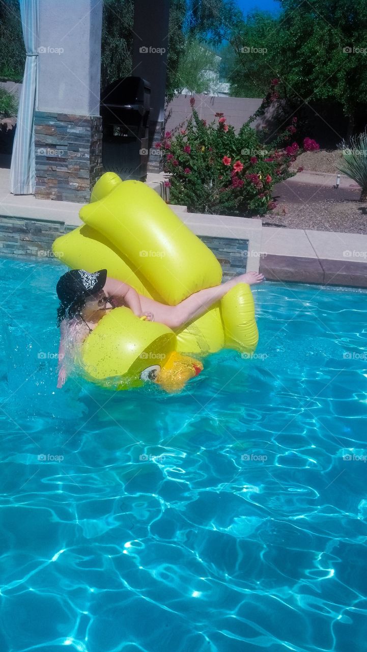 Girl falling from yellow duck lifebuoy