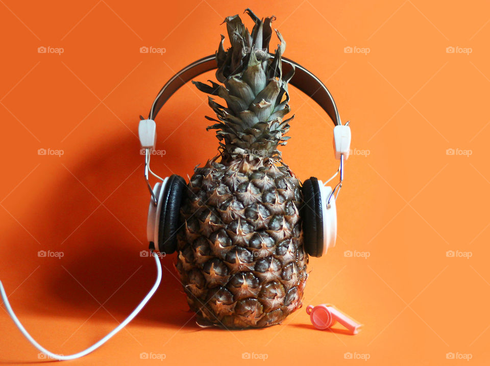 A pineapple with headphones