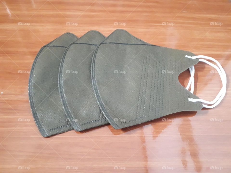 a display of brown masks on ceramic with brown wooden nuances