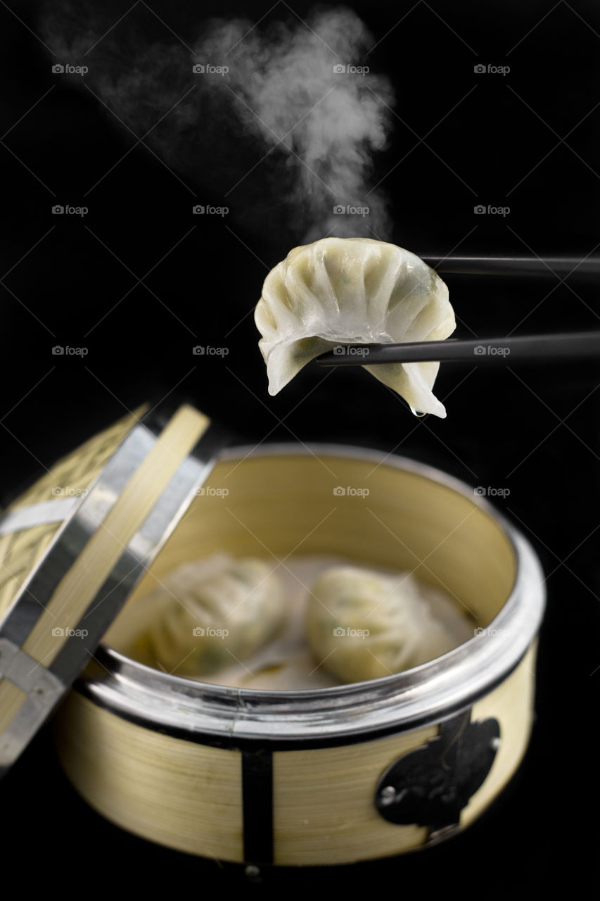 close up of freshly steamed dim sum isolated on a black background